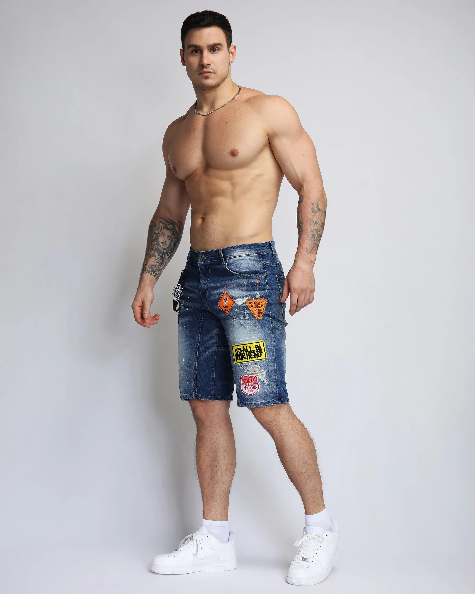 Ripped Blue Denim Shorts with Personality Badge in Medium Wash