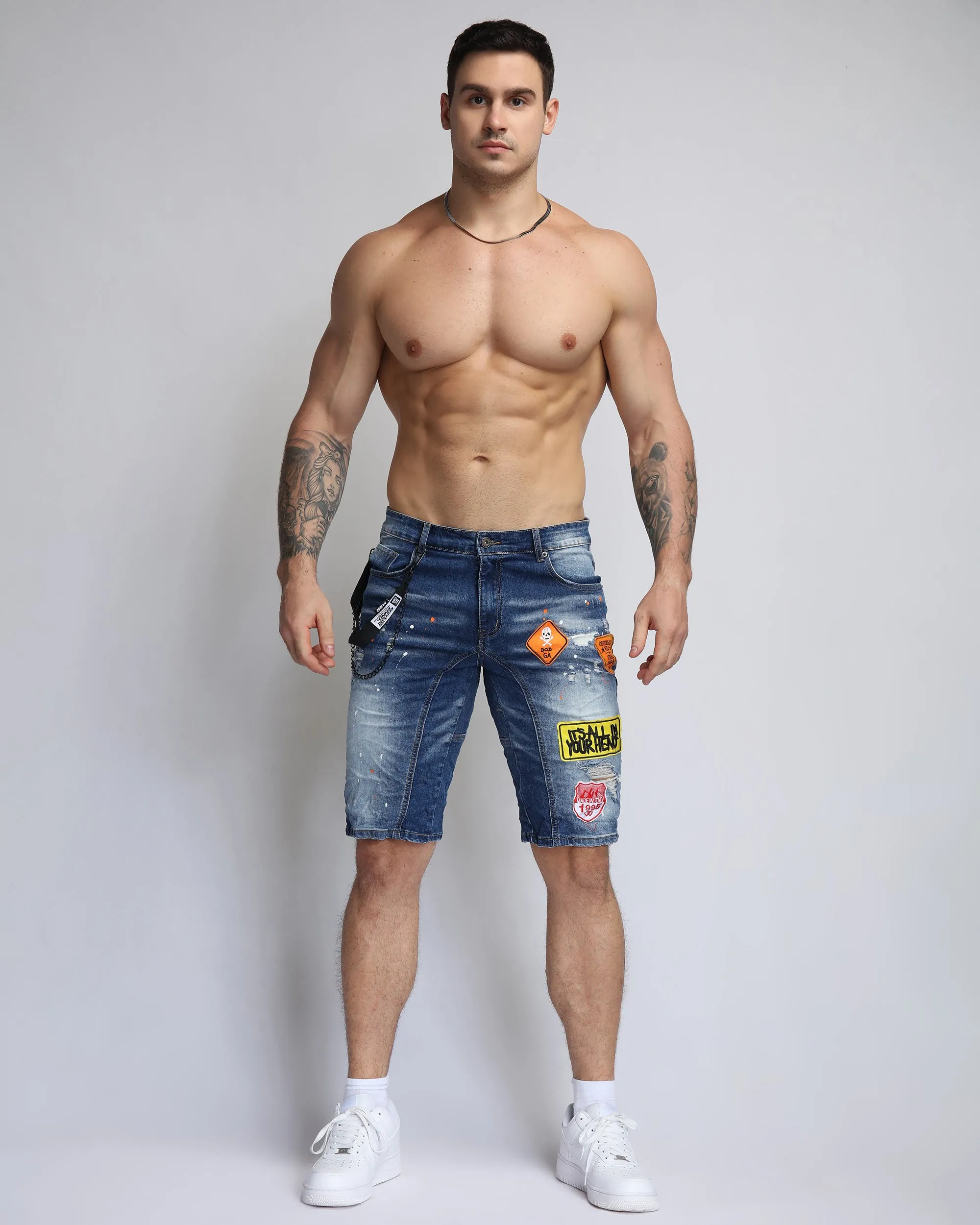 Ripped Blue Denim Shorts with Personality Badge in Medium Wash